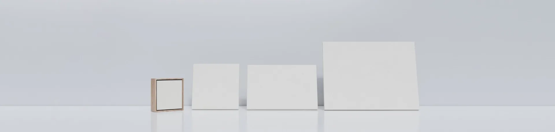 The framed miniature beside three larger blank canvases, from 20 by 20 centimetres to 30 by 40 centimetres